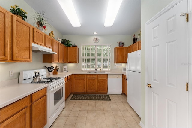 12687 SE 90th Ter, Summerfield, FL 34491 - kitchen featuring white appliances, under cabinet range hood, a sink, light countertops, and light tile patterned floors