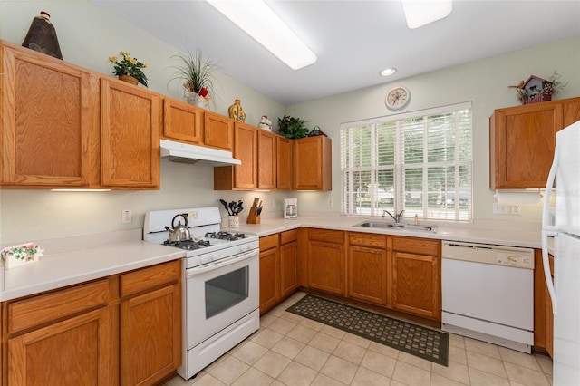 12687 SE 90th Ter, Summerfield, FL 34491 - kitchen featuring white appliances, under cabinet range hood, a sink, light countertops, and light tile patterned flooring