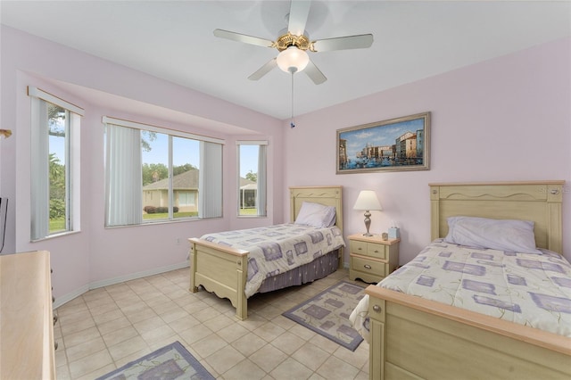12687 SE 90th Ter, Summerfield, FL 34491 - bedroom featuring light tile patterned floors, baseboards, and a ceiling fan