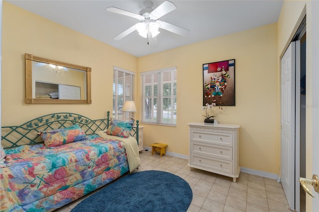12687 SE 90th Ter, Summerfield, FL 34491 - bedroom with light tile patterned floors, baseboards, a ceiling fan, and a closet