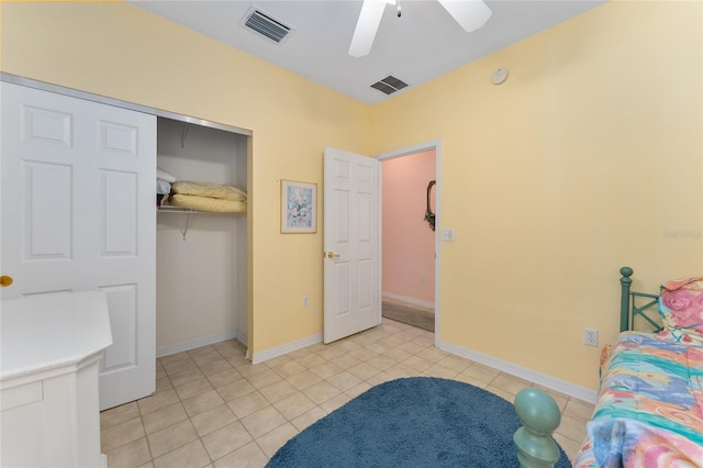 12687 SE 90th Ter, Summerfield, FL 34491 - bedroom featuring light tile patterned floors, a closet, ceiling fan, and baseboards