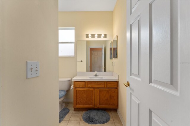 12687 SE 90th Ter, Summerfield, FL 34491 - half bathroom featuring tile patterned flooring, toilet, vanity, and baseboards