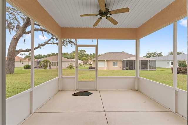 12687 SE 90th Ter, Summerfield, FL 34491 - unfurnished sunroom featuring a ceiling fan and a residential view