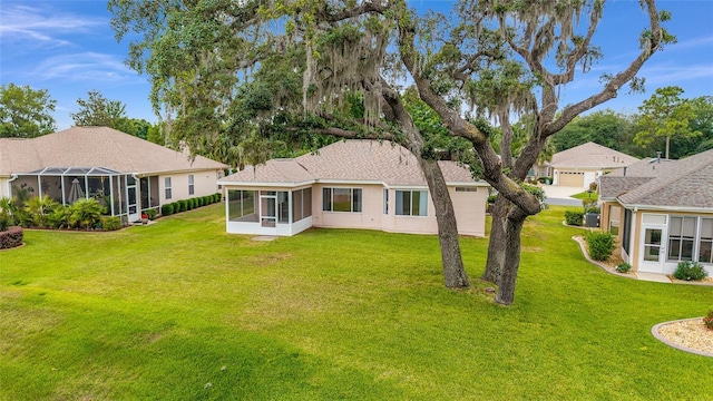 12687 SE 90th Ter, Summerfield, FL 34491 - rear view of property featuring a sunroom, a lawn, and stucco siding