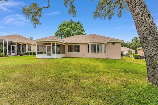 12687 SE 90th Ter, Summerfield, FL 34491 - rear view of house with a sunroom, a yard, stucco siding, cooling unit, and a shingled roof