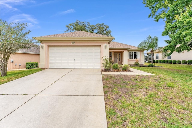 12687 SE 90th Ter, Summerfield, FL 34491 - view of front of house featuring stucco siding, a front yard, a garage, and concrete driveway