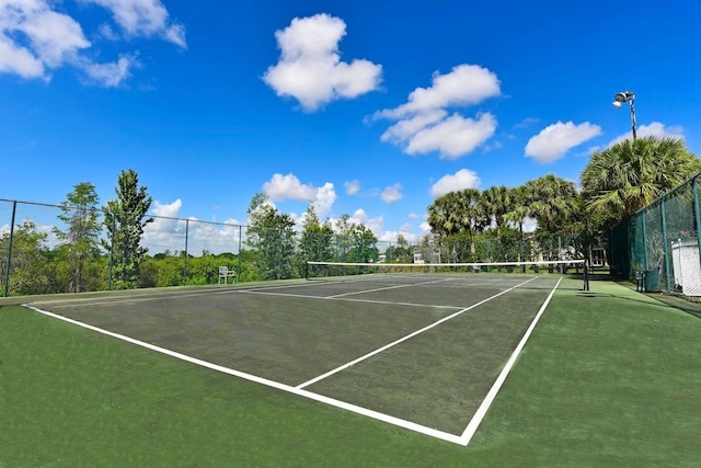 view of tennis court featuring fence