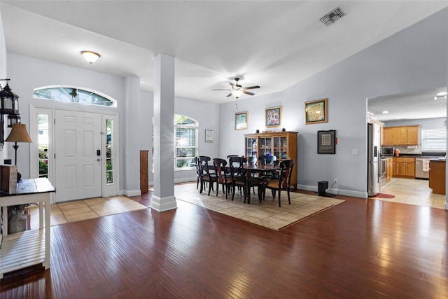 foyer entrance featuring light wood-style flooring, a ceiling fan, and baseboards