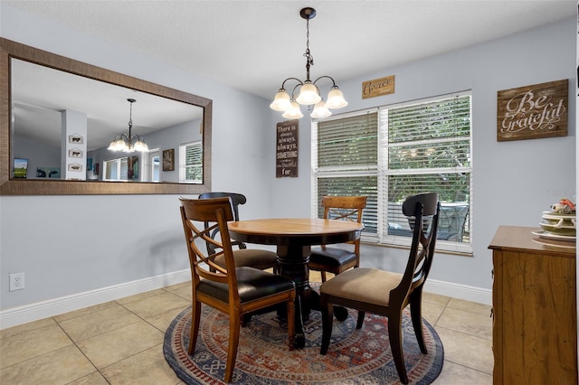 dining room featuring a chandelier, light tile patterned flooring, and baseboards