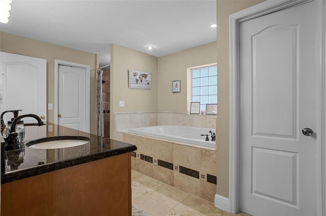 bathroom with a bath, tile patterned flooring, vanity, a tile shower, and recessed lighting