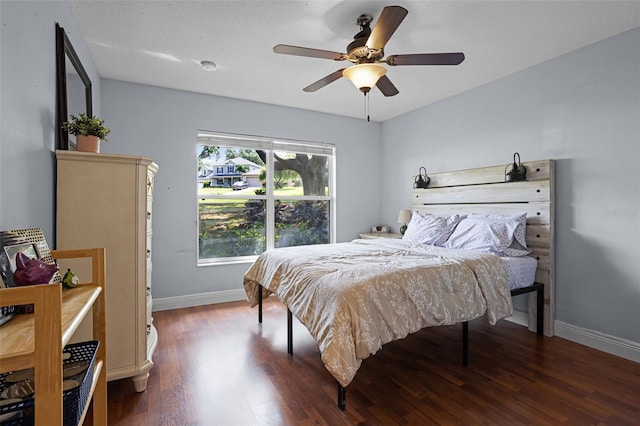 bedroom with wood finished floors, baseboards, and ceiling fan