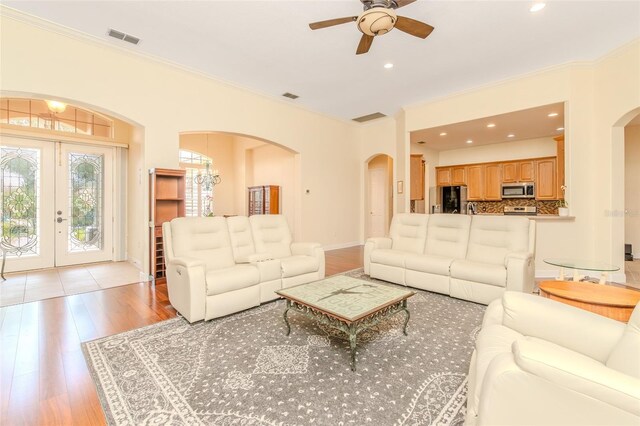537 Montage Ln, Kissimmee, FL 34759 - living area featuring arched walkways, crown molding, a ceiling fan, french doors, and recessed lighting