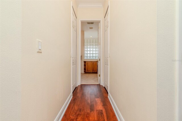 537 Montage Ln, Kissimmee, FL 34759 - hallway featuring dark wood-type flooring, ornamental molding, and baseboards