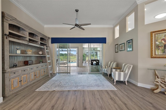 2125 Horizon Run, The Villages, FL 32162 - living area featuring a ceiling fan, baseboards, wood finished floors, ornamental molding, and a textured ceiling