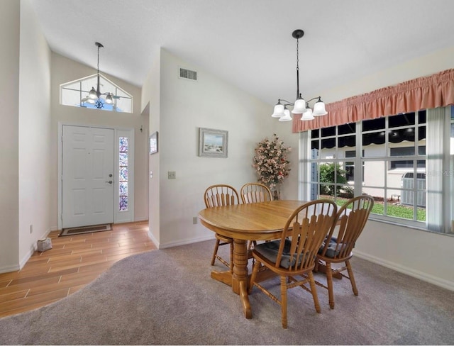 239 Juniper Way, Tavares, FL 32778 - dining room with a chandelier, vaulted ceiling, baseboards, and wood finished floors