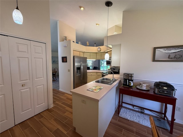 239 Juniper Way, Tavares, FL 32778 - kitchen with stainless steel appliances, a peninsula, a high ceiling, wood finish floors, and light countertops