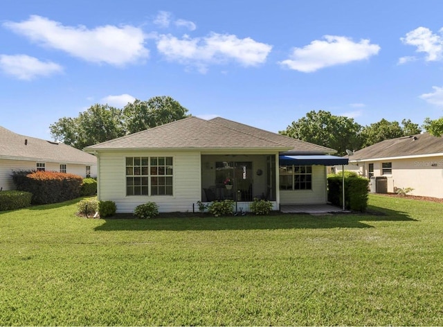 239 Juniper Way, Tavares, FL 32778 - rear view of property featuring a lawn and roof with shingles