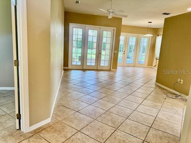 3083 Pinnacle Ct, Clermont, FL 34711 - unfurnished room with light tile patterned floors, ceiling fan, and french doors