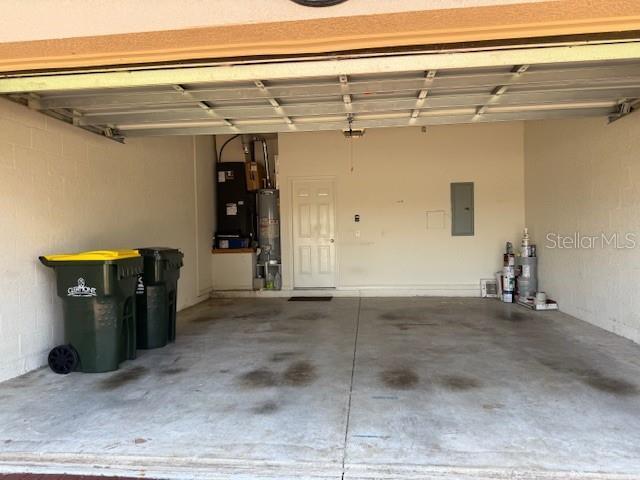 3083 Pinnacle Ct, Clermont, FL 34711 - garage with electric panel and water heater