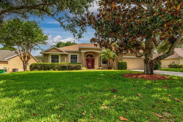 3141 Brighton Rd, Eustis, FL 32726 - single story home with driveway, a front yard, stucco siding, a garage, and central AC unit