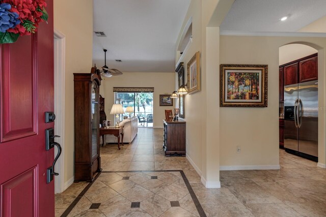3141 Brighton Rd, Eustis, FL 32726 - foyer with baseboards, inlaid floor details, a ceiling fan, arched walkways, and recessed lighting