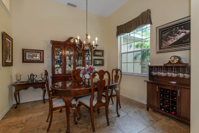 3141 Brighton Rd, Eustis, FL 32726 - tiled dining space featuring a chandelier, baseboards, and a high ceiling