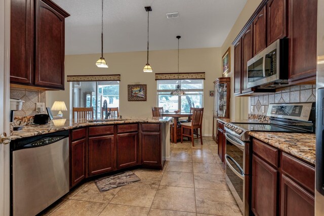 3141 Brighton Rd, Eustis, FL 32726 - kitchen with appliances with stainless steel finishes, a sink, a peninsula, backsplash, and healthy amount of natural light