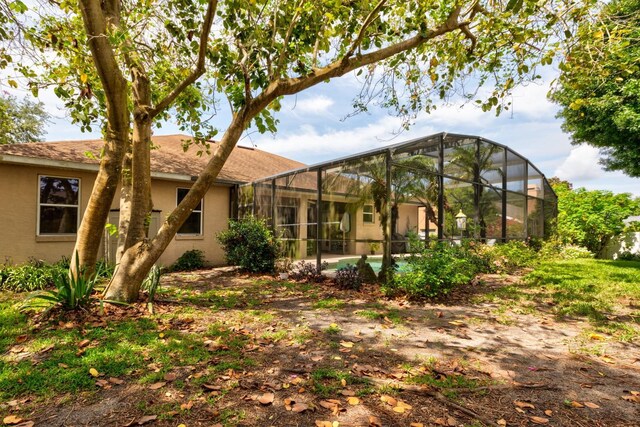 3141 Brighton Rd, Eustis, FL 32726 - back of property with stucco siding and glass enclosure