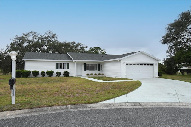 ranch-style house with a garage, a front lawn, and concrete driveway