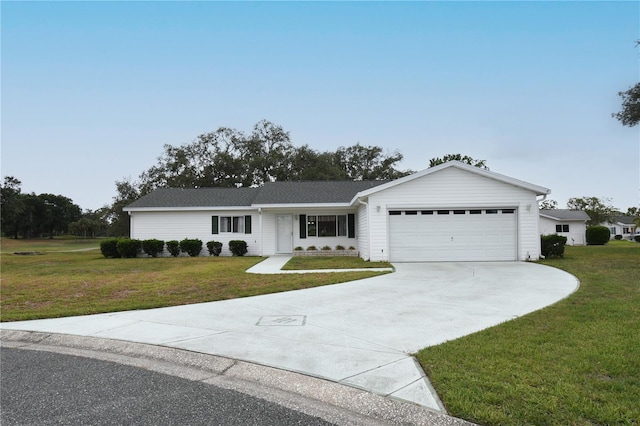 single story home featuring a front yard, a garage, and concrete driveway