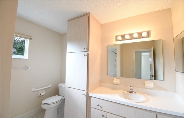 bathroom featuring toilet, vanity, a textured ceiling, and tile patterned flooring
