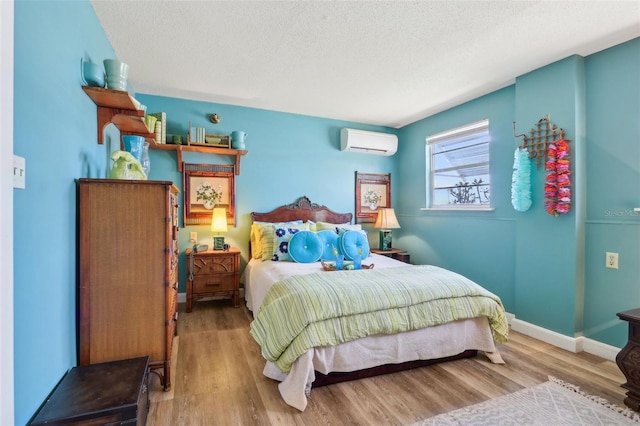1301 N Ave, Tavares, FL 32778 - bedroom with an AC wall unit, wood finished floors, a textured ceiling, and baseboards
