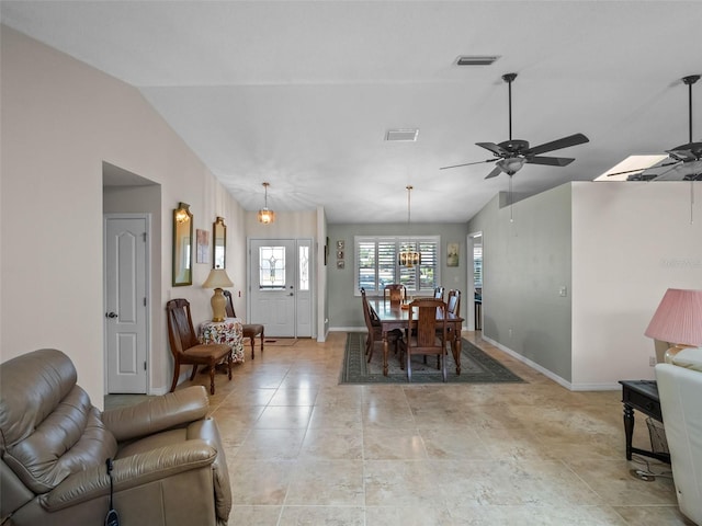dining room with vaulted ceiling, baseboards, and ceiling fan