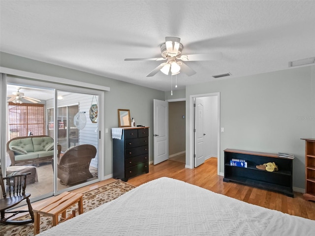 bedroom featuring access to outside, wood finished floors, baseboards, and ceiling fan