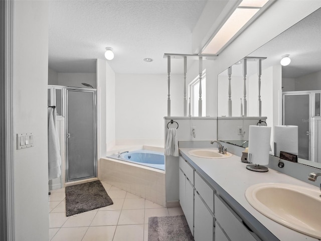 bathroom featuring a shower stall, a bath, tile patterned floors, a textured ceiling, and double vanity