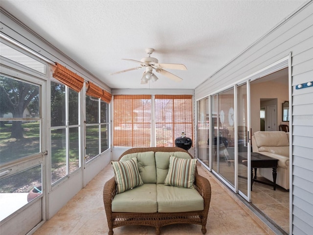 sunroom featuring a ceiling fan and plenty of natural light