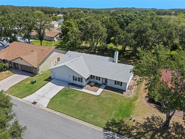 view from above of property with a heavily wooded area