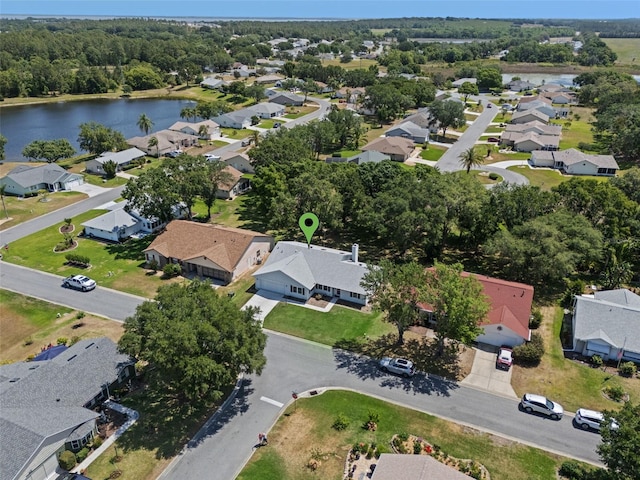aerial overview of property's location with a nearby body of water and nearby suburban area