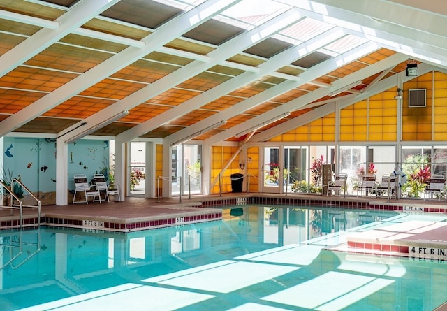 indoor community pool featuring a patio area