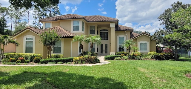 8719 Kenmure Cv, Orlando, FL 32836 - view of front of property featuring french doors, a tile roof, and a front lawn