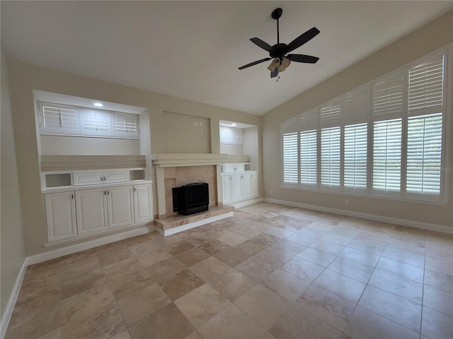 8719 Kenmure Cv, Orlando, FL 32836 - unfurnished living room featuring baseboards, vaulted ceiling, ceiling fan, a high end fireplace, and built in shelves