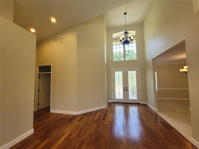 8719 Kenmure Cv, Orlando, FL 32836 - foyer entrance with a chandelier, a towering ceiling, french doors, dark wood-style floors, and baseboards
