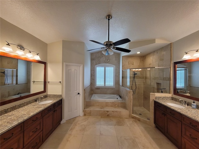 8719 Kenmure Cv, Orlando, FL 32836 - bathroom with a garden tub, a shower stall, a textured ceiling, two vanities, and a ceiling fan