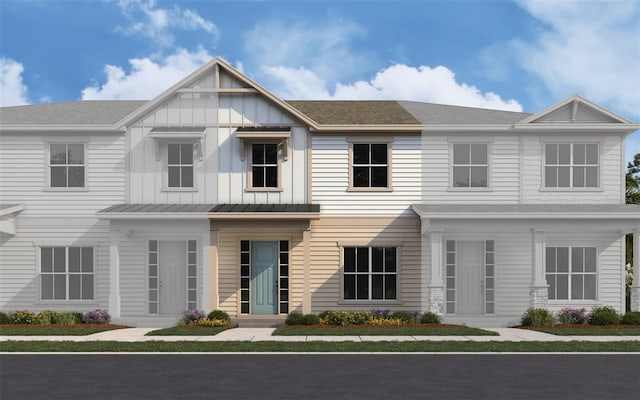 townhome / multi-family property featuring a shingled roof and a standing seam roof