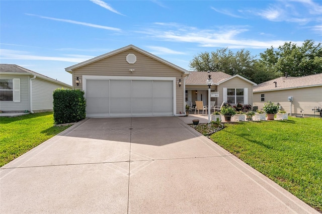 ranch-style house featuring a front yard, driveway, and an attached garage