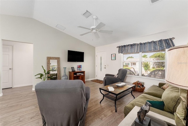 living area featuring vaulted ceiling, light wood-style flooring, ceiling fan, and baseboards