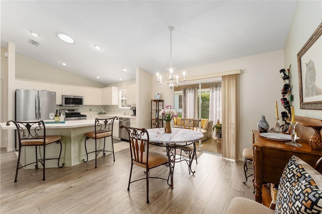 dining space featuring a chandelier, vaulted ceiling, light wood-type flooring, and recessed lighting