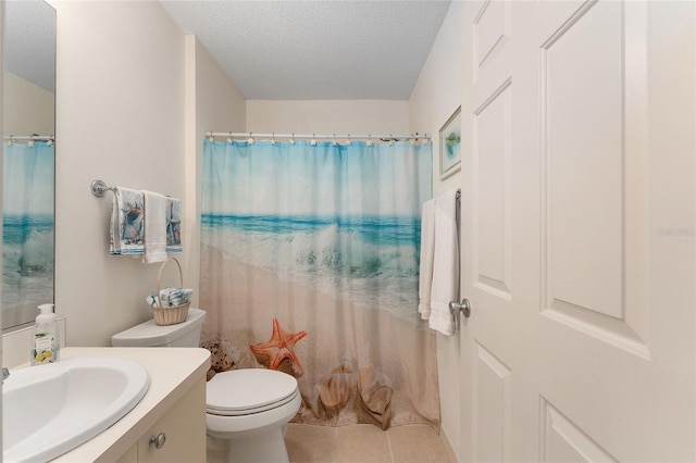 bathroom featuring a textured ceiling, vanity, tile patterned flooring, toilet, and a shower with curtain