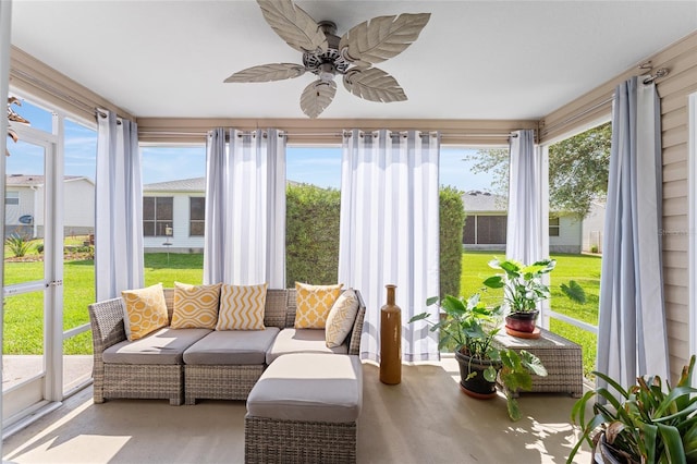 sunroom / solarium featuring a ceiling fan