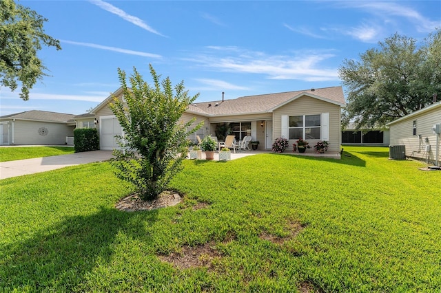 view of front of property featuring central air condition unit, an attached garage, a front yard, and concrete driveway